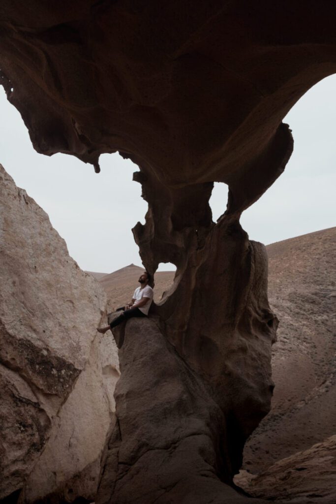 Man sitting on high rock